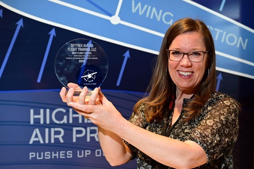 Jamie Patterson-Simes from SkyTrek Alaska Flight Training receives recognition as the best flight school in the Northwest Mountain region during the 2019 AOPA Flight Training Experience Awards in Denver, October 16, 2019. Photo by David Tulis.